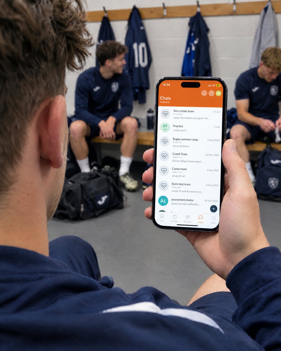 Footballer in the changing room after training reading the team chats in the SportMember app